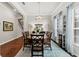 Formal dining room with hardwood floors, a stylish chandelier, and a large dining table at 15212 Kestrelrise Dr, Lithia, FL 33547