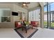 Relaxing covered patio with red couches and a coffee table at 15212 Kestrelrise Dr, Lithia, FL 33547