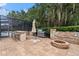 Entertaining backyard oasis with fire pit, outdoor kitchen, and seating at 15212 Kestrelrise Dr, Lithia, FL 33547