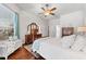 Bright bedroom with king-size bed, hardwood floors, and large windows at 15212 Kestrelrise Dr, Lithia, FL 33547