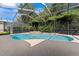 Inviting kidney-shaped pool with spa and screened enclosure at 15212 Kestrelrise Dr, Lithia, FL 33547