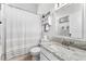 Well-appointed bathroom with granite countertop and striped shower curtain at 15212 Kestrelrise Dr, Lithia, FL 33547