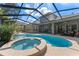 Relaxing pool and spa with covered patio, outdoor kitchen and seating area at 15212 Kestrelrise Dr, Lithia, FL 33547
