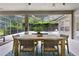Covered patio with wooden dining table and chairs, overlooking the pool at 15212 Kestrelrise Dr, Lithia, FL 33547
