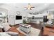 Spacious living area with hardwood floors, a large TV, and comfortable seating at 15212 Kestrelrise Dr, Lithia, FL 33547