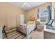 Cozy guest bedroom with a full-size bed, dresser, and window coverings at 15212 Kestrelrise Dr, Lithia, FL 33547