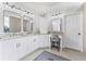 Modern bathroom with double vanity, large mirrors, and a walk-in shower at 15212 Kestrelrise Dr, Lithia, FL 33547