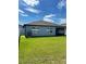 Home's exterior back view, showcasing a large grassy backyard at 918 Coastal Hammock Ave, Ruskin, FL 33570