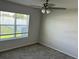 Well-lit bedroom with carpeted floor and a large window at 918 Coastal Hammock Ave, Ruskin, FL 33570