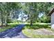 Long paved driveway leading to home with mature trees at 8921 Honeywell Rd, Gibsonton, FL 33534