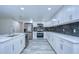 Modern kitchen boasts white cabinets, quartz countertops, and a stylish backsplash at 8921 Honeywell Rd, Gibsonton, FL 33534