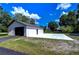 Detached garage with a large concrete driveway at 8921 Honeywell Rd, Gibsonton, FL 33534