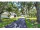 Home with long driveway, detached garage, and mature trees at 8921 Honeywell Rd, Gibsonton, FL 33534