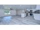Open concept kitchen with white cabinets, stainless steel appliances, and quartz countertops at 8921 Honeywell Rd, Gibsonton, FL 33534