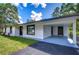 Front view of a renovated home with covered porch at 8921 Honeywell Rd, Gibsonton, FL 33534