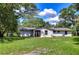 Back of house showing French doors and large yard at 8921 Honeywell Rd, Gibsonton, FL 33534