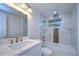 Bathroom features a white vanity, marble tile, and a bathtub at 8921 Honeywell Rd, Gibsonton, FL 33534
