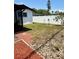 Landscaped backyard with a privacy fence, minimal foliage, and easy access to screened porch at 11452 81St Pl, Seminole, FL 33772