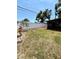 Wide backyard features privacy fence, young foliage, and access to screened-in porch at 11452 81St Pl, Seminole, FL 33772