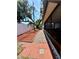 The brick path is bordered by red mulch, leading towards a screened in lanai at 11452 81St Pl, Seminole, FL 33772