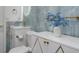 Elegant bathroom featuring blue marble style tile, gold hardware, and a modern floating sink at 11452 81St Pl, Seminole, FL 33772
