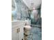 Elegant bathroom featuring blue marble style tile, glass shower and upscale gold hardware at 11452 81St Pl, Seminole, FL 33772