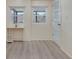 Bedroom with a desk, two windows, vinyl floors, and access to a bright hallway at 11452 81St Pl, Seminole, FL 33772