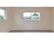 Neutral bedroom with two windows offering plenty of natural light and wood laminate flooring at 11452 81St Pl, Seminole, FL 33772