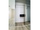 Walk-in closet with mirrored sliding doors, hanging rod, and built-in safe for secure storage at 11452 81St Pl, Seminole, FL 33772