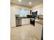 This kitchen features white cabinets, stainless steel appliances, and granite countertops at 11452 81St Pl, Seminole, FL 33772