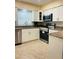 This kitchen features white cabinets, stainless steel appliances, and granite countertops at 11452 81St Pl, Seminole, FL 33772