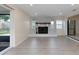 Spacious living room with a fireplace, sliding glass door, and an adjoining modern kitchen at 11452 81St Pl, Seminole, FL 33772