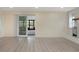 Spacious living room with sliding glass door to the patio and a modern decorative fireplace at 11452 81St Pl, Seminole, FL 33772