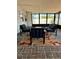 Relaxing screened porch with brick flooring, comfortable seating, and bright floral rug at 11452 81St Pl, Seminole, FL 33772
