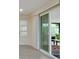 Bright room with a sliding door leading to the outside and a door with rectangular panes at 11452 81St Pl, Seminole, FL 33772