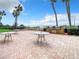 Outdoor grilling area with tables and chairs, perfect for entertaining at 3820 Gulf Blvd # 1001, St Pete Beach, FL 33706