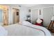 Bedroom with white bedding and access to closets at 3820 Gulf Blvd # 1001, St Pete Beach, FL 33706