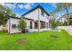 Stunning modern home showcasing manicured lawn and beautiful outdoor patio seating at 4625 W El Prado Blvd, Tampa, FL 33629
