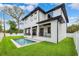 Backyard with a rectangular pool, lush grass, a modern white home and a white fence at 4625 W El Prado Blvd, Tampa, FL 33629