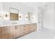 A well-lit bathroom with dual vanities, sleek mirrors, elegant lighting, and modern fixtures at 4625 W El Prado Blvd, Tampa, FL 33629
