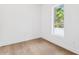 A simple bedroom with hardwood floors and one bright window, all in a neutral color at 4625 W El Prado Blvd, Tampa, FL 33629