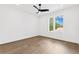 Bright bedroom with wood floors, ceiling fan, and natural light from large windows at 4625 W El Prado Blvd, Tampa, FL 33629