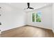 Clean, bright bedroom with wood floors, ceiling fan, and a pair of bright windows at 4625 W El Prado Blvd, Tampa, FL 33629