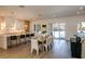 Open concept dining area with light wood floors and modern light fixtures at 4625 W El Prado Blvd, Tampa, FL 33629