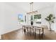 Light-filled dining room showcases modern decor, hardwood flooring, and a stylish chandelier, perfect for entertaining at 4625 W El Prado Blvd, Tampa, FL 33629