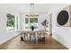 Bright dining room with wood floors, modern lighting, and a stylish table set with seating for six guests at 4625 W El Prado Blvd, Tampa, FL 33629