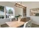 Sunlit dining room showcasing a wooden table, chandelier, and tasteful decor at 4625 W El Prado Blvd, Tampa, FL 33629