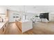 Bright kitchen with island, quartz countertops, wood cabinets, stainless steel appliances, and open to the living area at 4625 W El Prado Blvd, Tampa, FL 33629
