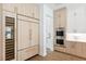 Modern kitchen featuring wood-grain cabinets, stainless steel appliances, and a built-in wine fridge at 4625 W El Prado Blvd, Tampa, FL 33629