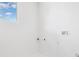 Bright laundry room with large window and utility connections at 4625 W El Prado Blvd, Tampa, FL 33629